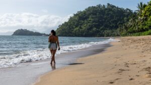 Woman walking along Trinity Beach, Cairns